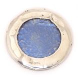 A photograph frame of circular form with a silver surround, hallmarked Chester 1906. Approx. 2 1/