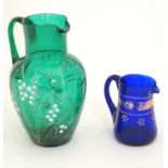 A Victorian green glass jug with white lily of the valley style floral decoration, together with a