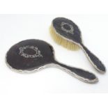 A silver and tortoiseshell backed hand mirror and brush, hallmarked Birmingham 1919 maker E S