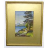 A 20thC watercolour depicting a figure on a lakeside path with mountains beyond. Signed with