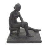A 20thC clay sculpture modelled as a seated ballerina. Singed J. Paul to base. Approx. 7 1/4" high