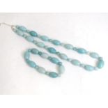 A jade coloured bead necklace together with a matching bracelet. The necklace approx. 18" long (2)