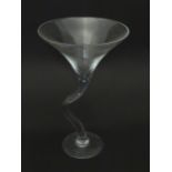 A large glass vase / shop display piece modelled as an oversized martini glass with a curved stem.