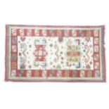 Carpet / Rug: A cream ground rug with red borders. Approx 59" x 33 1/2" Please Note - we do not make