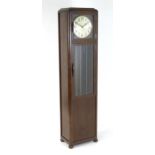 An Art Deco / mid century longcase clock, the mahogany case with glazed doors. Approx. 74" tall,