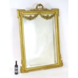 A 19thC Neo-classical style mirror of giltwood and gesso construction, having garland crest and swag