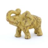 An Oriental ceramic model of an elephant with painted detail. Marked under. Approx. 7" long Please