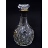 A cut glass decanter with silver collar. Hallmarked Sheffield 1957 maker Mappin & Webb 9 1/4" high