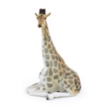A Russian Lomonosov pottery model of a seated giraffe. Marked under. Approx. 11 3/4" high Please