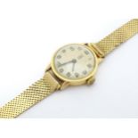 A French 18ct gold cased wristwatch with Arabic numerals with yellow metal bracelet. The case approx
