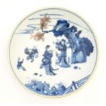 A Chinese blue and white dish decorated with figures in a garden landscape. Character marks under.