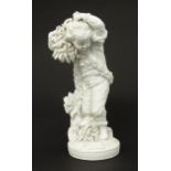 A Derby bisque porcelain figure from The Seasons modelled as Autumn, a boy holding crops on a