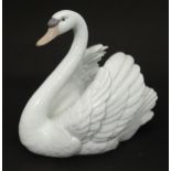 A Lladro model of a swan, model no. 5231. Marked under. Approx. 7" high Please Note - we do not make