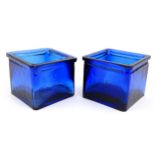 Two blue glass jardinieres of squared form. Approx 4" high Please Note - we do not make reference to