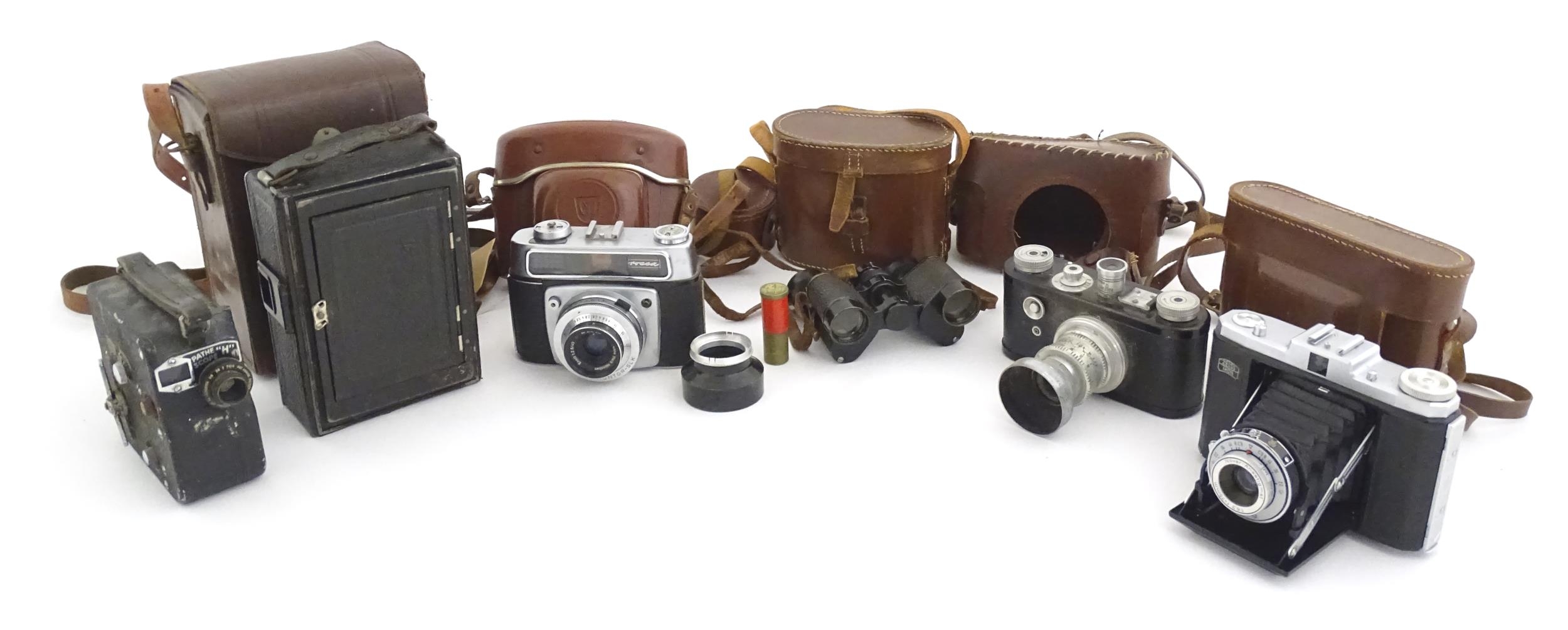 A quantity of 20thC cased cameras to include a Zeiss Ikon Nettar 517/16 camera, a Corfield