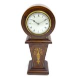 A mahogany mantle clock with inlaid detail and white enamel dial with movement by Duverdrey &
