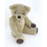 A 20thC mohair teddy bear with moving mouth mechanism, stitched nose, pad paws and articulated