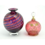 A cranberry glass scent bottle with hand painted floral detail. Approx 4" high, Together with