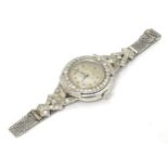 A platinum and white metal ladies wrist watch set with a profusion of diamonds. The case approx. 3/