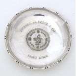 A silver dish of circular form with inset Hong Kong 1971 One Dollar coin to centre, and engraved