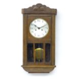 An Art deco oak wall clock. Approx 25" high Please Note - we do not make reference to the