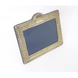 An easel back photograph frame with silver surround hallmarked Sheffield 1991, maker DR&S. Approx.