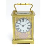 A French brass cased carriage clock with hand painted porcelain panels, the movement stamped ACC