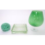 A green glass paperweight / doorstop 4" high and a green glass oversized brandy glass 10 1/2" high .