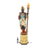 A mid 20thC blackamoor lamp, the lamp having a polychrome figural top grasping a torchiere, the