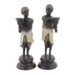 Two 20thC cast Blackamoor figural candlesticks with painted detail. Largest approx. 10" high (2)