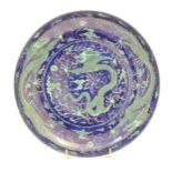 A Chinese plate with a blue ground and green decoration depicting with dragons, flaming pearl and