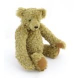 Toy: A Ruben Bears mohair teddy bear with hump back, glass eyes, stitches nose and mouth, suede paws