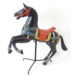 Toy: A late 20thC wooden model of a stylised carousel horse / galloper with carved and polychrome