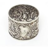 A Victorian silver napkin ring with embossed putti decoration hallmarked London 1897 Please Note -