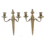 A pair of cast metal twin branch wall candle sconces with floral and foliate detail. Approx. 15 1/2"