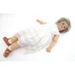 Toy: A large Simon & Halbig bisque head socket doll with composite body and jointed limbs. Marked to