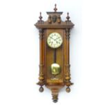 A walnut cased Vienna style wall clock. Approx 38" high overall Please Note - we do not make