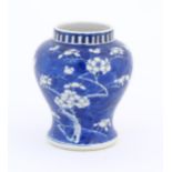 A Chinese blue and white vase decorated with blossom. Character marks under. Approx. 6 1/4" high