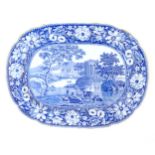 A Victorian blue and white meat plate with a floral border, decorated with a landscape scene with