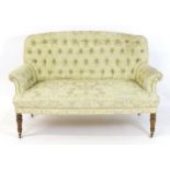 An early / mid 20thC settee with a deep buttoned backrest above two scrolled arms and a sprung seat.