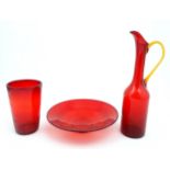 A Whitefriars red glass vase together with a red glass bowl and a tall jug with amber loop handle.