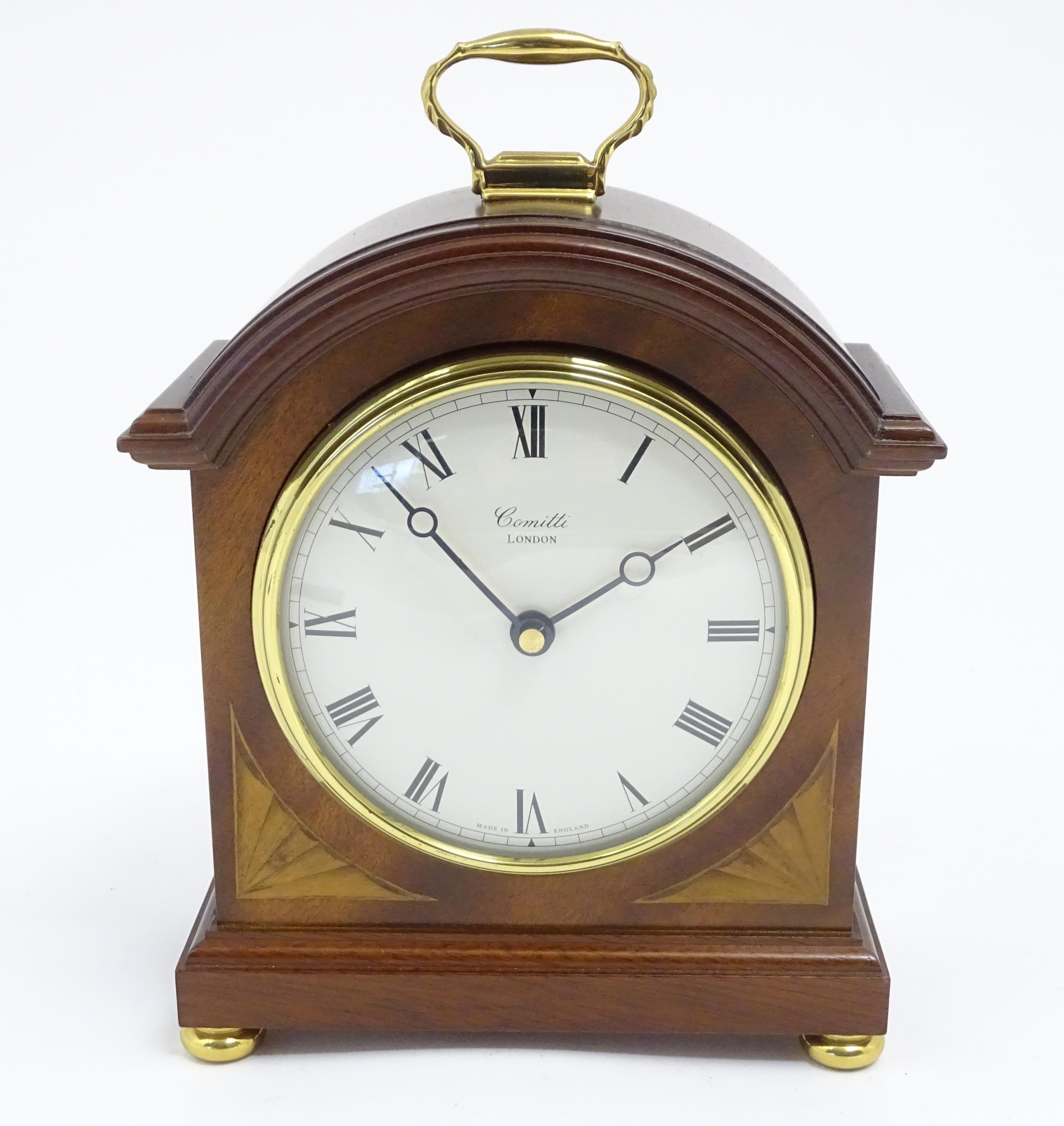 A Comitti battery powered mantel clock. Approx 8 1/2" high Please Note - we do not make reference to