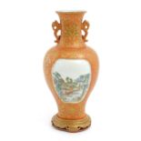 A Chinese vase with a burnt orange ground decorated with gilt floral, foliate and bat detail, and