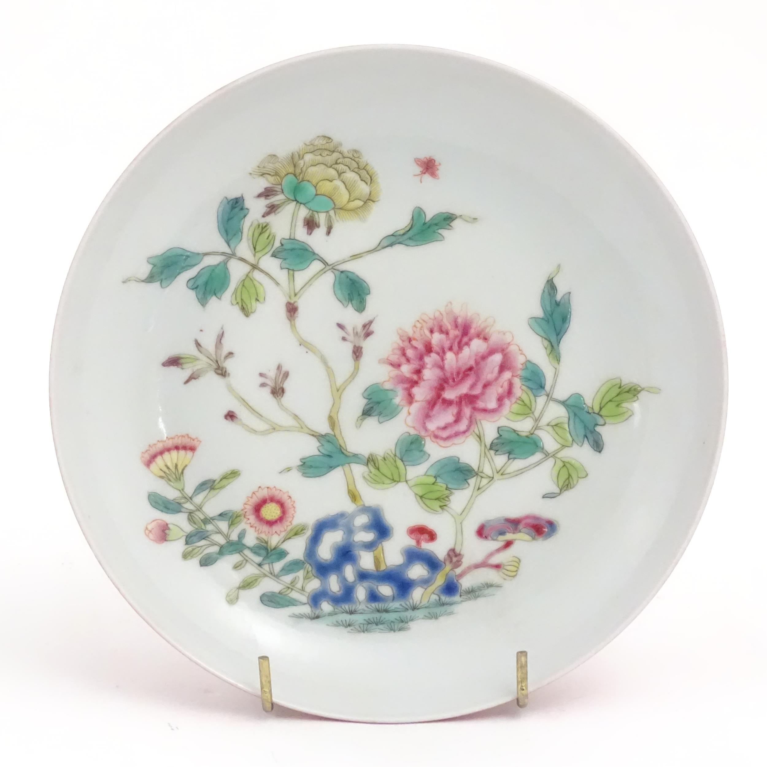 A small Chinese famille rose plate decorated with a stylised rocky outcrop with flowers and foliage. - Image 3 of 5