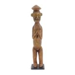 Ethnographic / Native / Tribal: An African carved wood standing figure. Approx. 18 3/4" high overall
