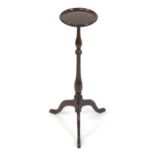 An early / mid 20thC mahogany torchière / jardinière stand, having a circular rimmed top above a