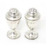 A pair of Victorian silver pepperettes, hallmarked Sheffield 1898, maker Harrison Brothers & Howson.