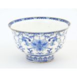 A Chinese blue and white bowl decorated with scrolling floral and foliate decoration. Character