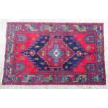 Carpet / rug : An Hamadan rug with burgundy, blue and red ground decorated with geometric motifs,