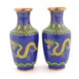 A pair of Oriental cloisonne vases decorated with two dragons and a flaming pearl amongst stylised